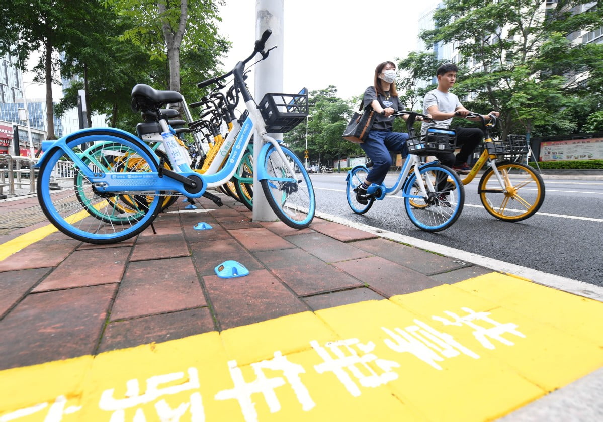 Users of shared bicycles are seen riding in Fuzhou, Fujian province, in June 2022