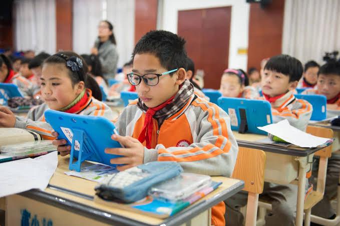 Fifth-graders use tablet computers in a math class in Tonglu, Zhejiang province