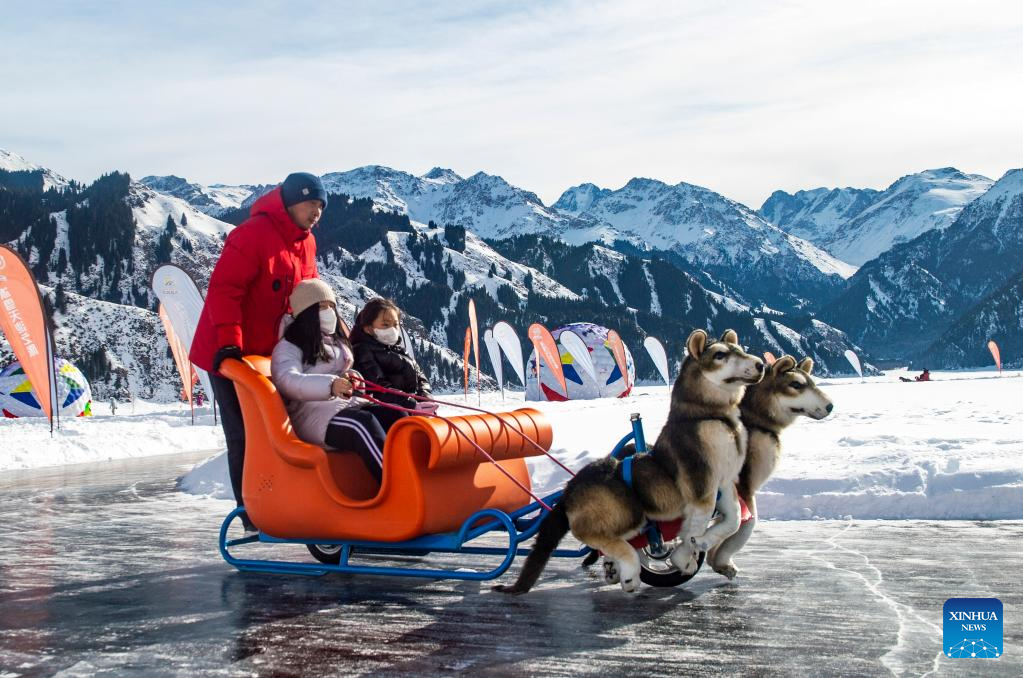 People ride a sled at Tianchi scenic area in Northwest China's Xinjiang Uygur autonomous region, Jan 24, 2023.