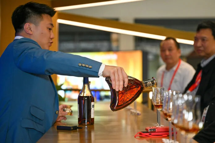 6434d962a31057c4b4b8eb87 Visitors taste products at Pernod Ricard's booth during the third China International Consumer Products Expo in Haikou, the capital of Hainan, on April 10, 2023.
