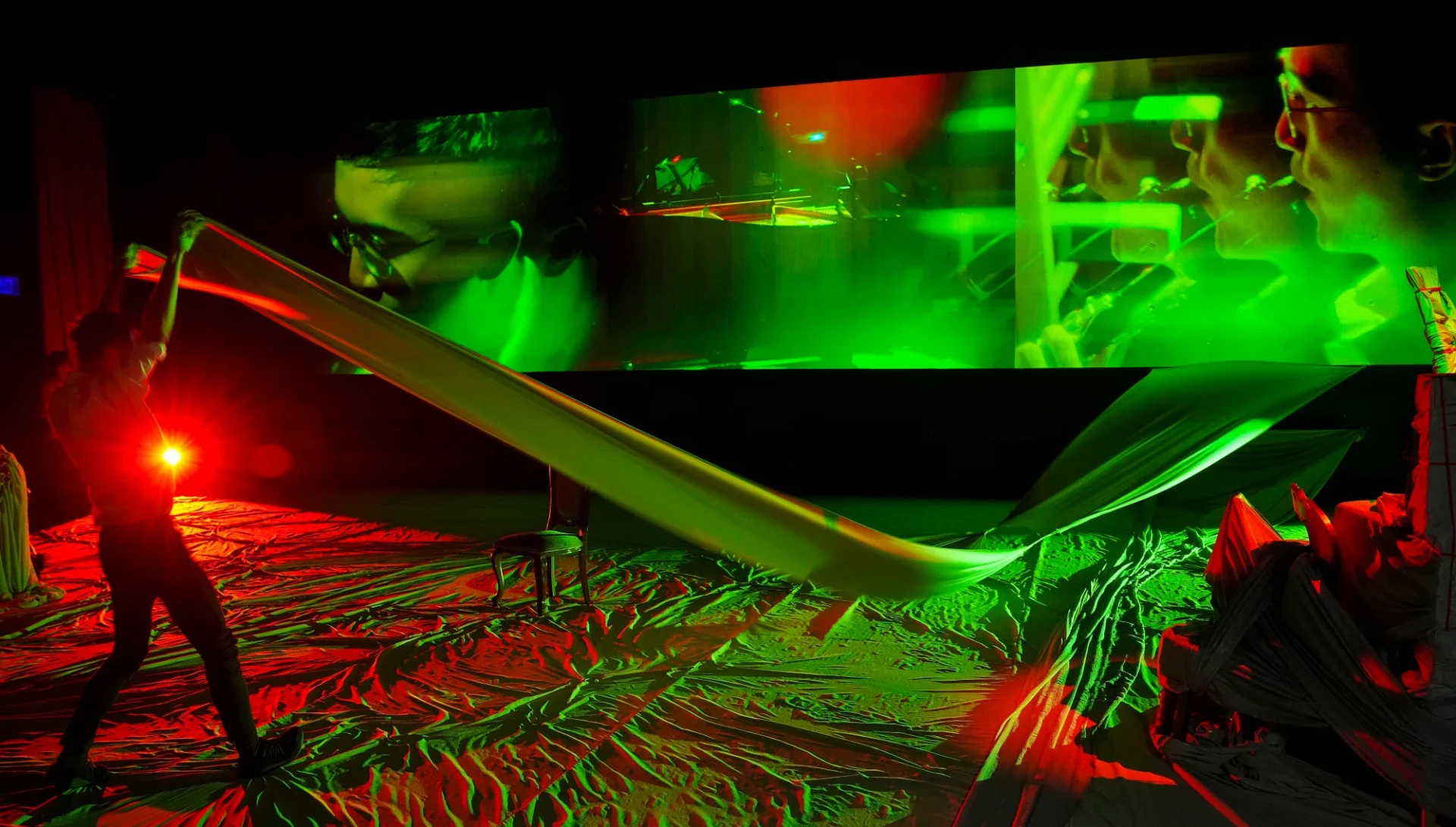 1ad2f515-8877-4422-8631-74eddd331cc9_2cc3c8a0 Actors appear beside video projections in “The Travellers and The Listeners”.