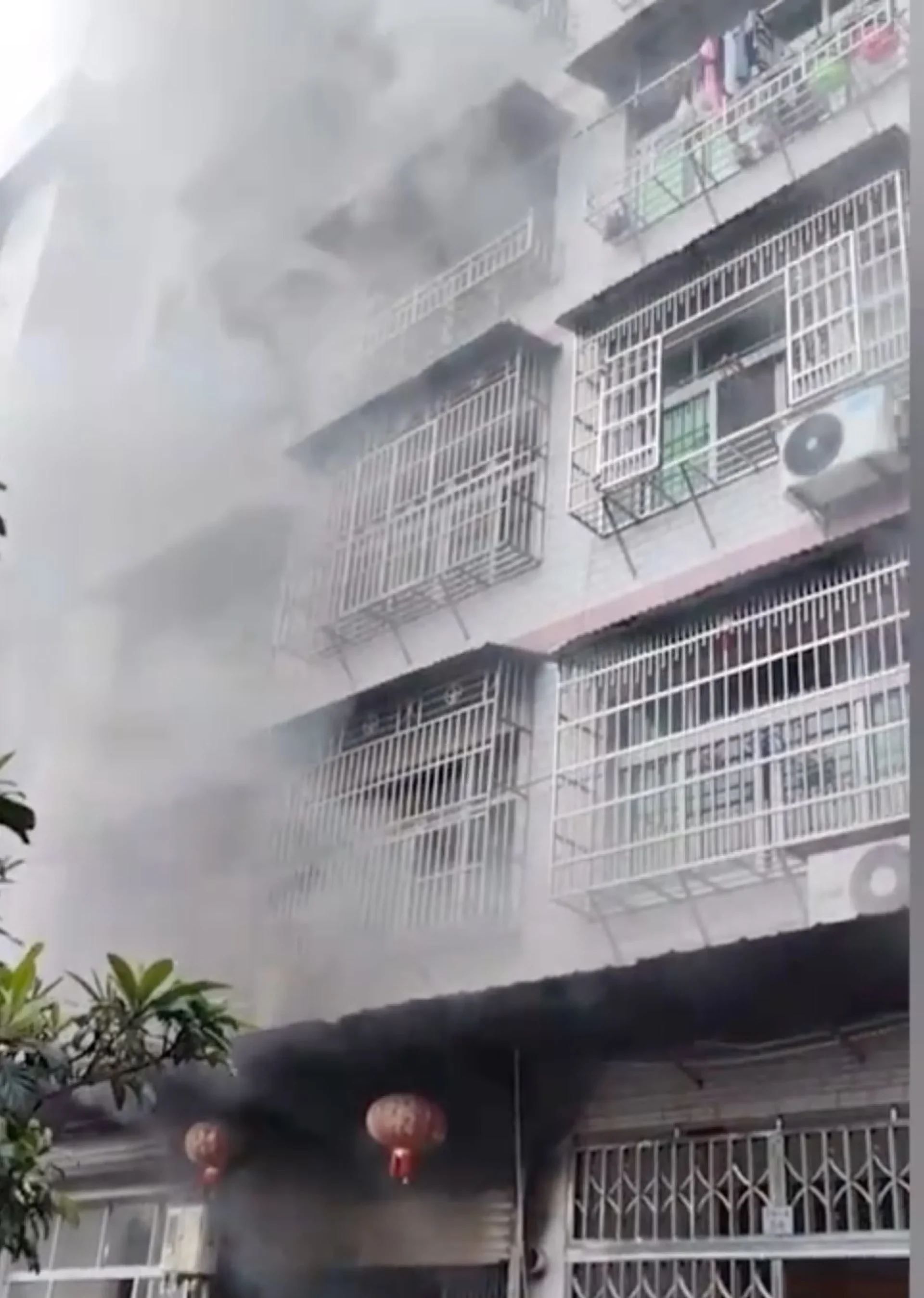 Thick smoke billows from the burning building