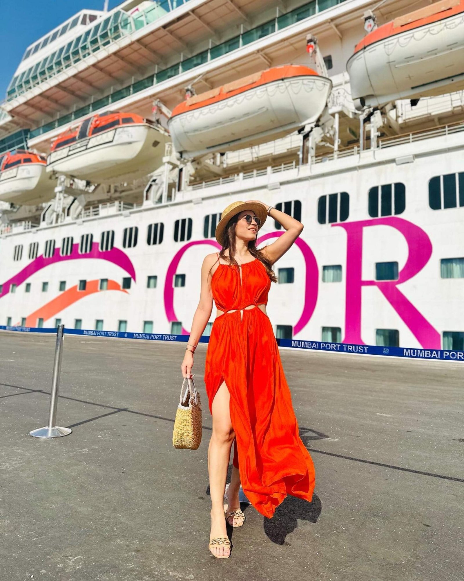 An Indian guest poses in front of the Cordelia Cruises ship Empress in Mumbai Port, India. Photo: Instagram/@kanika_kh