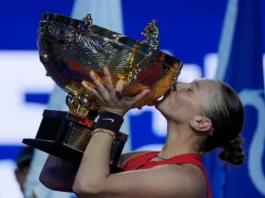 Anisimova wins China Open, holding trophy on court.