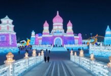 Harbin Ice Festival's glowing ice sculptures and lanterns at night.