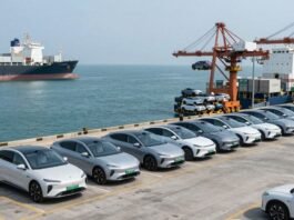 Chinese electric cars being loaded onto a cargo ship for export.