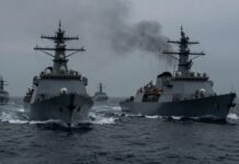 Naval warships in the Strait of Hormuz amid tensions.