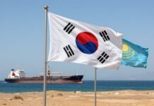 South Korean and Kazakh flags with oil tanker at sea.