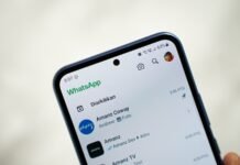 EU Demands Meta Restore AI Chatbot Access on WhatsApp Amid Antitrust Probe A person holding a cell phone in their hand