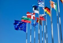 a bunch of flags that are flying in the air