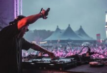 man in grey t-shirt playing dj mixer